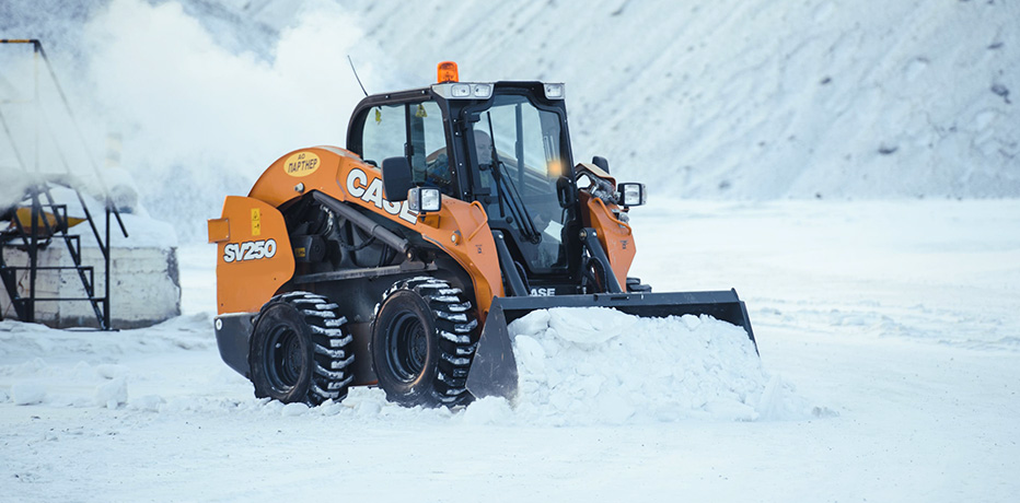 Фото мини-погрузчика Case SV250B, оборудованного снегоуборочным ковшом, в процессе снегоуборочных работ